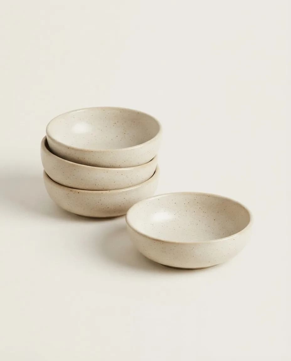 Stack of four ivory speckled stoneware bowls