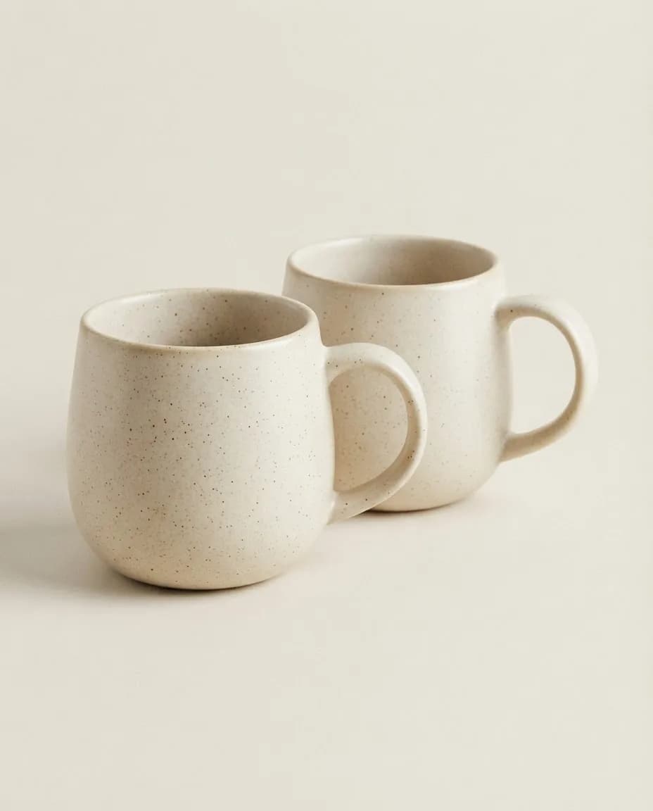 Two ivory speckled stoneware mugs